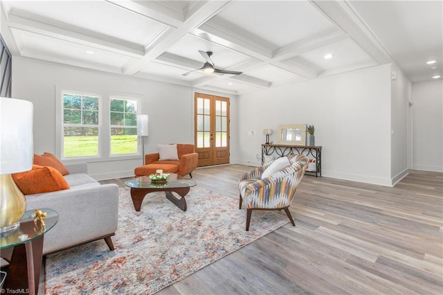 interior space with french doors, light hardwood / wood-style flooring, ceiling fan, and beam ceiling