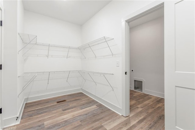 spacious closet featuring hardwood / wood-style flooring