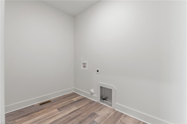 laundry area with hardwood / wood-style floors, hookup for a gas dryer, hookup for a washing machine, and electric dryer hookup