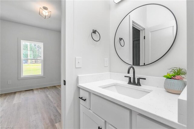 bathroom with vanity and hardwood / wood-style flooring