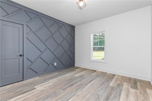 spare room featuring light hardwood / wood-style floors