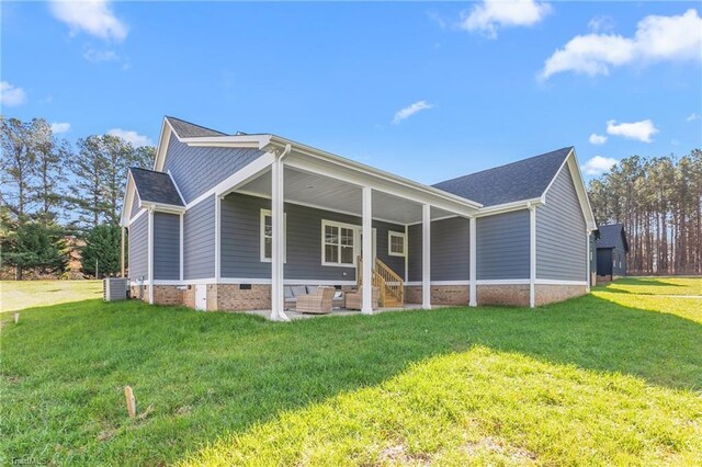 view of front of property featuring a porch, central air condition unit, and a front yard