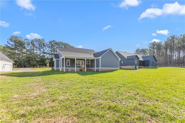 rear view of property with a yard