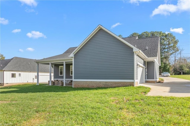 exterior space featuring a yard, covered porch, and a garage