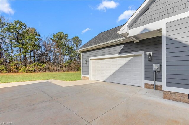 garage featuring a lawn