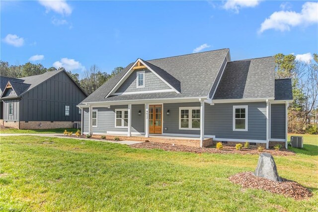 view of front of house featuring central air condition unit, a front lawn, and a porch