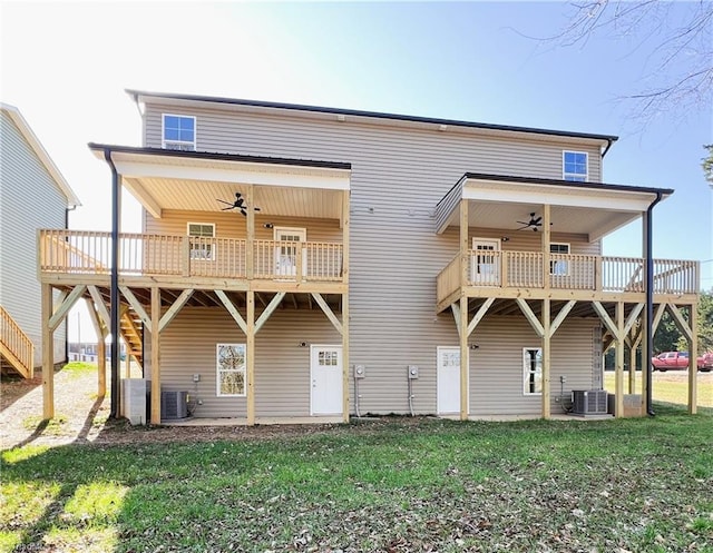 rear view of property with a yard, ceiling fan, and central air condition unit