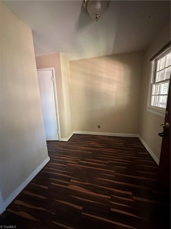 spare room with dark hardwood / wood-style flooring