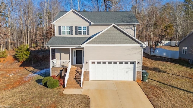 front facade with a front yard, a garage, and covered porch