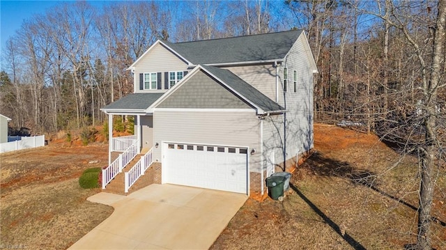 view of front of property with a porch and a garage