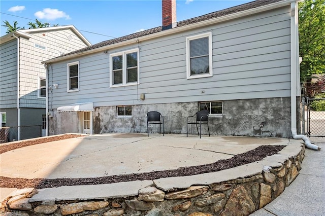 2075 Craig St, Winston-Salem, NC 27103 - rear view of house with a patio and a chimney