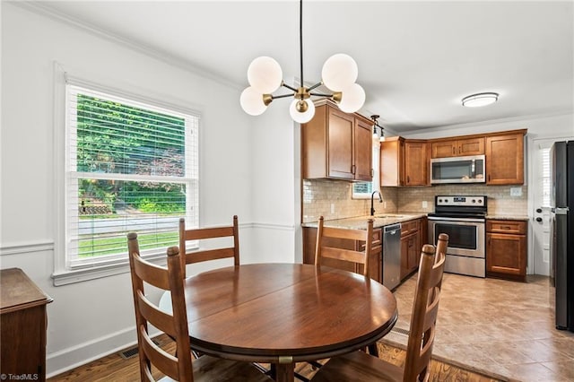 2075 Craig St, Winston-Salem, NC 27103 - dining space featuring crown molding, a chandelier, and baseboards