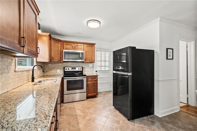 2075 Craig St, Winston-Salem, NC 27103 - kitchen featuring stainless steel appliances, a sink, ornamental molding, decorative backsplash, and light stone countertops