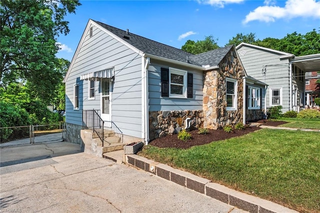 2075 Craig St, Winston-Salem, NC 27103 - view of front of house featuring stone siding, a gate, and a shingled roof