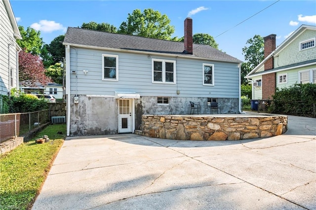 2075 Craig St, Winston-Salem, NC 27103 - back of house featuring a patio area, a chimney, and central AC unit