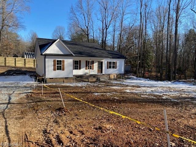 back of property with crawl space and fence