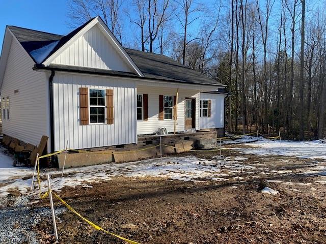 view of front of property with crawl space and board and batten siding