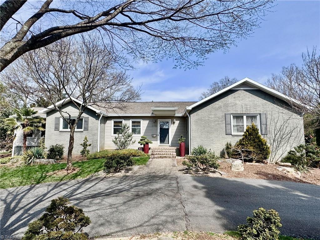 ranch-style house with brick siding and a shingled roof