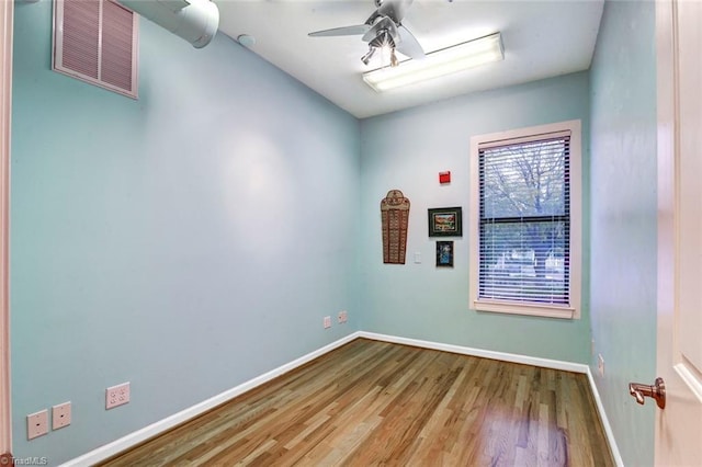 empty room featuring ceiling fan and hardwood / wood-style floors