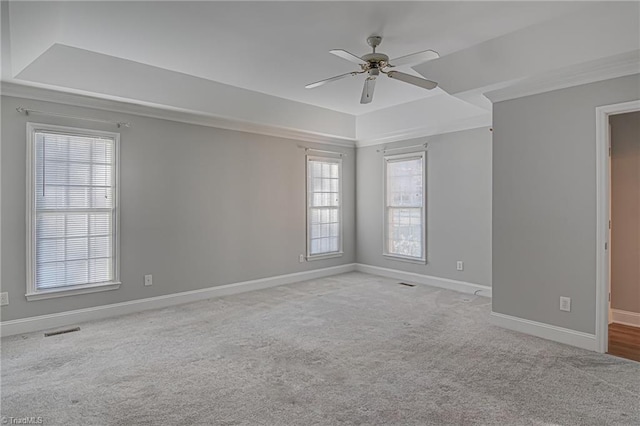 carpeted spare room with ceiling fan and ornamental molding