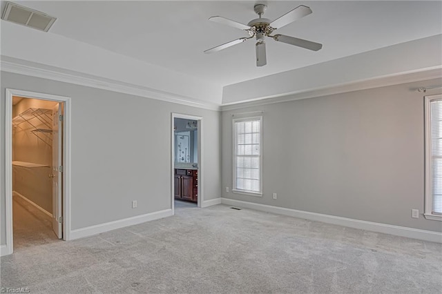 spare room featuring light colored carpet and ceiling fan