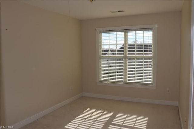 empty room featuring light colored carpet