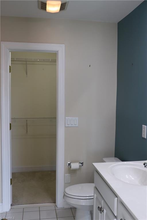 bathroom with tile patterned flooring, vanity, and toilet