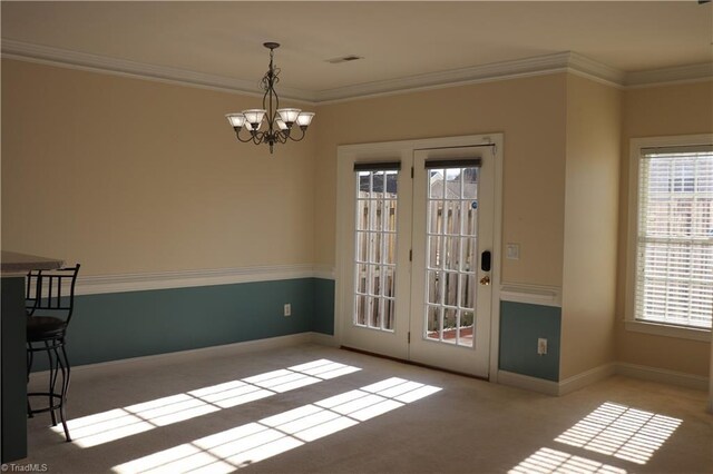 unfurnished dining area featuring light colored carpet, crown molding, a wealth of natural light, and a notable chandelier