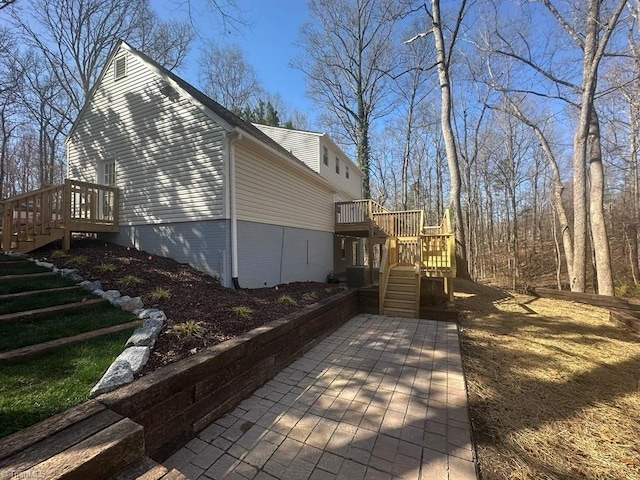 view of side of property with a wooden deck and stairs