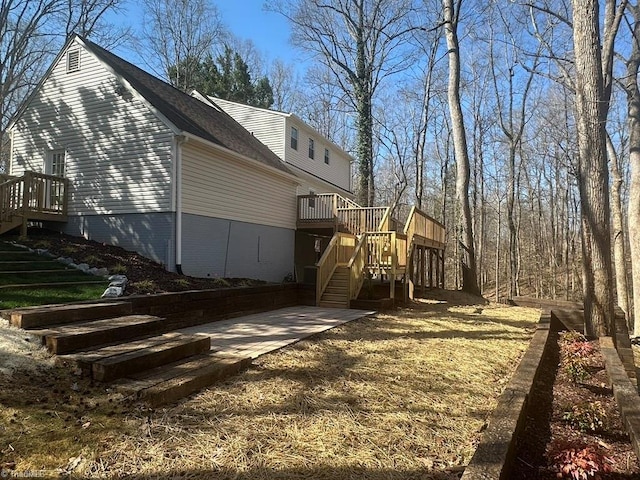 view of side of home with a patio area, stairway, and a wooden deck