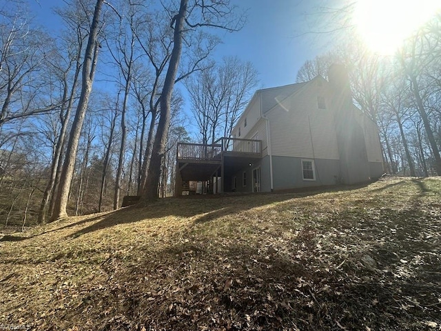 view of side of property with stairs and a wooden deck