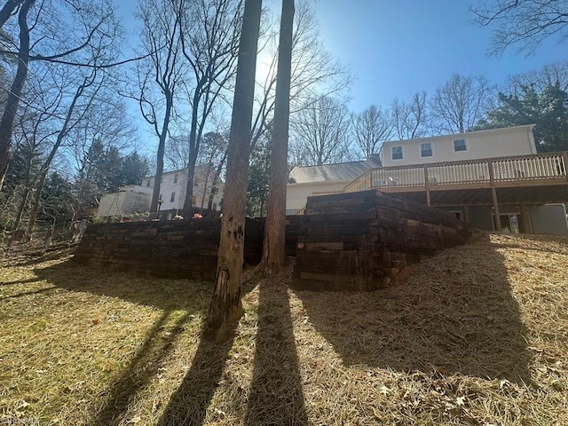 view of yard featuring a wooden deck and fence