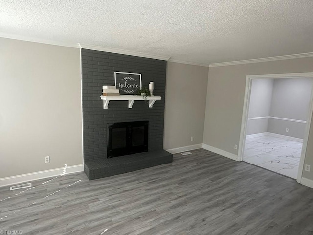 unfurnished living room featuring wood finished floors, a fireplace, visible vents, and baseboards