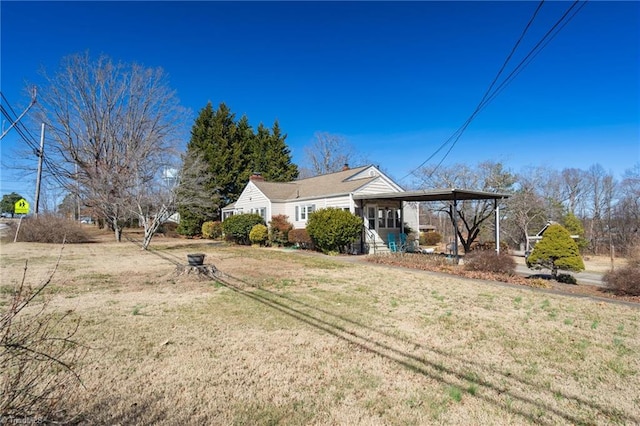 back of property featuring a lawn and a chimney