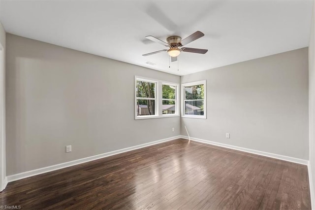 unfurnished room with dark wood-type flooring and ceiling fan