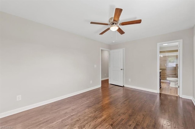 unfurnished bedroom with connected bathroom, dark hardwood / wood-style floors, and ceiling fan