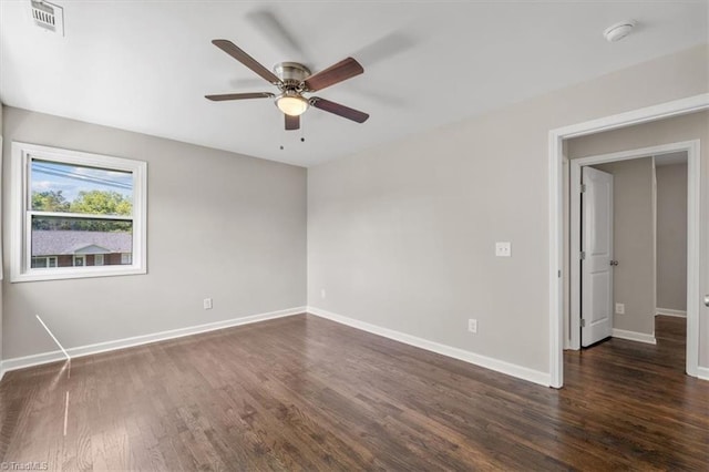 spare room featuring dark hardwood / wood-style floors and ceiling fan