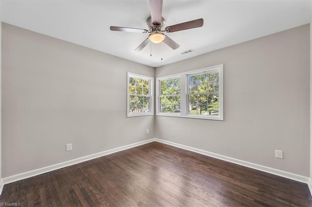 unfurnished room with ceiling fan and dark hardwood / wood-style flooring