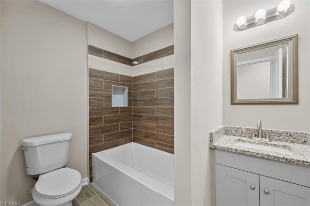 full bathroom with tiled shower / bath combo, vanity, and toilet