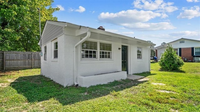 rear view of property with a yard