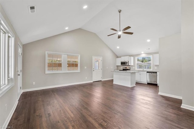 unfurnished living room featuring high vaulted ceiling, dark hardwood / wood-style floors, and ceiling fan