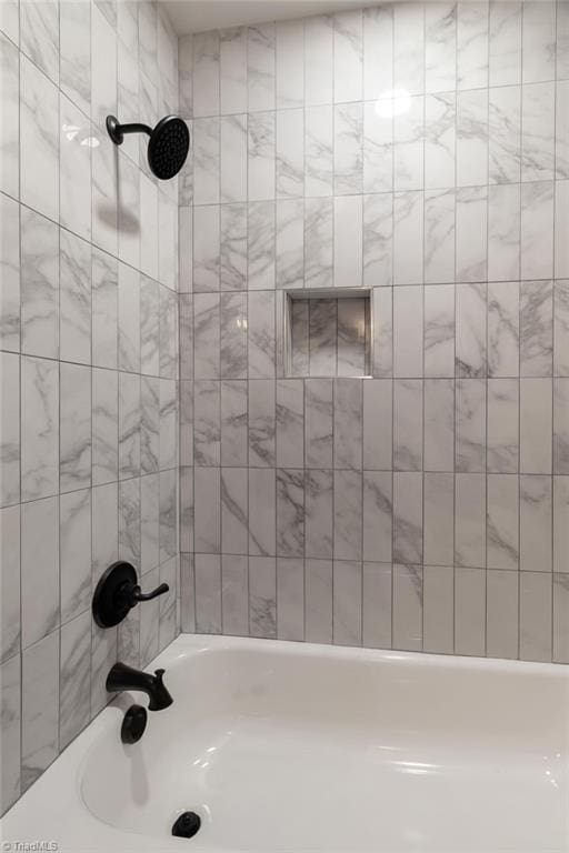 bathroom featuring washtub / shower combination