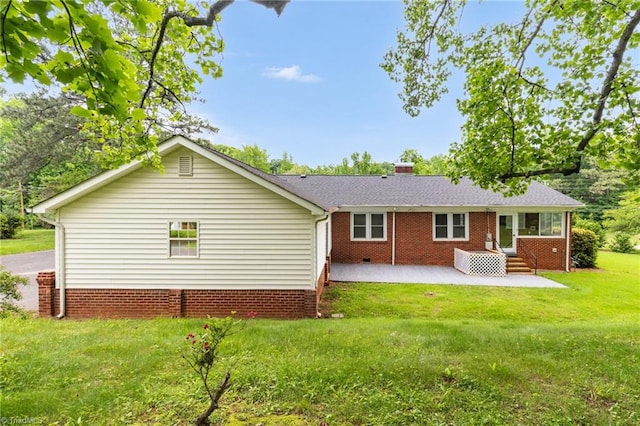 rear view of property featuring a patio area, a yard, entry steps, and crawl space