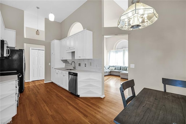 kitchen featuring open shelves, a sink, stainless steel appliances, white cabinets, and light countertops