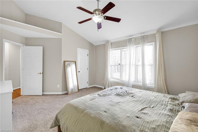 bedroom with carpet flooring, baseboards, lofted ceiling, and a ceiling fan