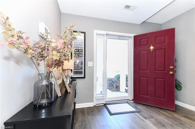 entryway with dark hardwood / wood-style floors