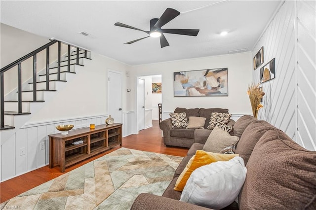 living room featuring wood-type flooring and ceiling fan