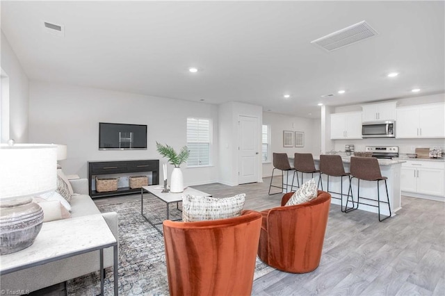 2126 Monk Dr, Haw River, NC 27258 - living room with baseboards, visible vents, recessed lighting, and light wood-type flooring