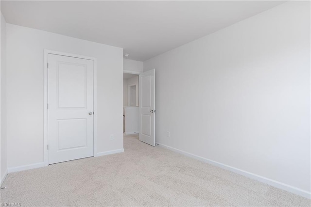 2126 Monk Dr, Haw River, NC 27258 - unfurnished bedroom with baseboards and carpet flooring