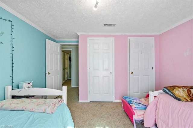 carpeted bedroom featuring crown molding and a textured ceiling